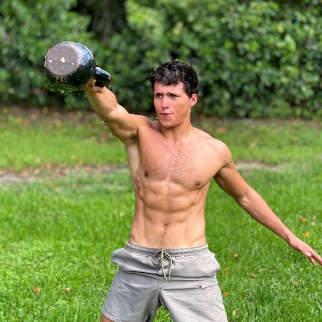 Andres Preschel holding a dumbbell doing exercise