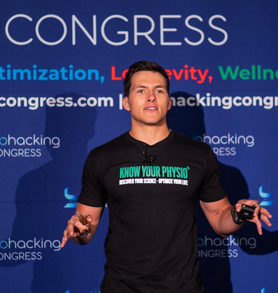 Andres Preschel Speaking on stage at Biohacking Congress Miami